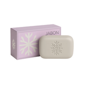 Bar of soap with a snowflake design next to a pink box labeled 'JABON' on a white background