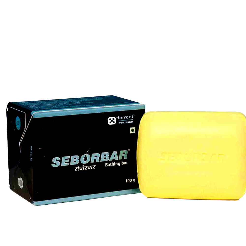 Yellow soap bar next to its packaging on a white background